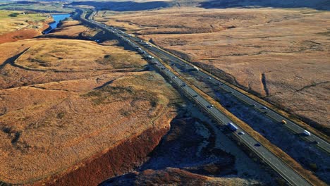 Aerial-View-of-the-busy-M62-Motorway-Ripponden-road-A672-and-Windy-Hill-Oldham,-Near-Saddleworth-Moor