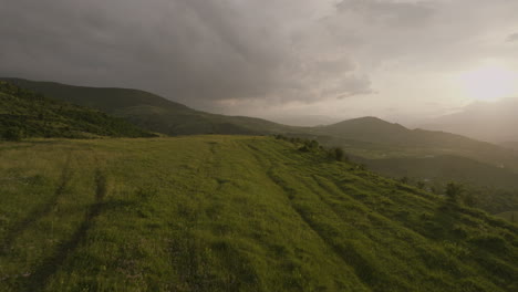 Flight-Over-Green-Fields-With-Lush-Mountains-Near-Akhaltsikhe,-Samtskhe-Javakheti,-Georgia---drone-shot