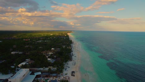 Aerial-view-of-a-resort-along-a-beautiful-white-sand-Akiin-beach,-Tulum,-Mexico