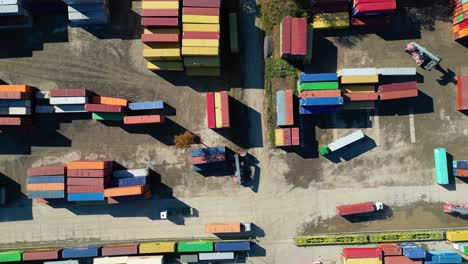 Aerial-view-of-shipping-containers,-semi-trucks-cargo-distribution-of-containers