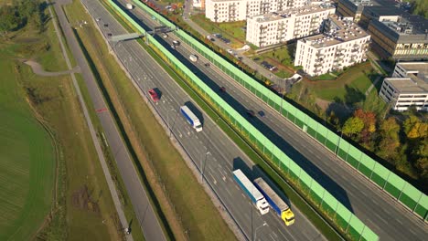 Beautiful-top-side-view-to-the-cars-driving-on-multi-level-highway-on-the-sunny-evening-in-Warsaw-Picturesque-aerial-panorama-of-the-road-traffic-and-sunset-city