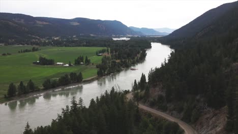 Wonderful-Aerial-Scene-of-the-South-Thompson-River-surrounded-by-farmland-in-Kamloops-British-Columbia-Canada-on-a-overcast-day-in-summer