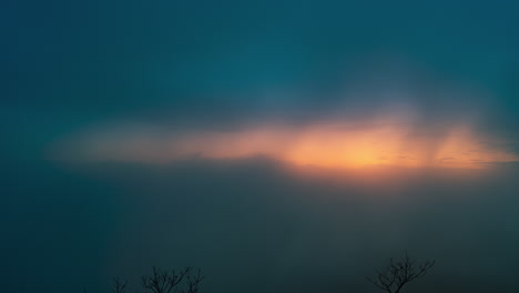 Fog-and-clouds-rolling-through-the-mountains-during-sunrise