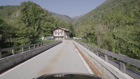 Driving-on-a-narrow-mountain-road-in-a-forest-in-the-Italian-Alps