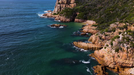 Aerial-over-rugged-coastline-of-Featherbed-Nature-Reserve,-The-Heads,-Knysna