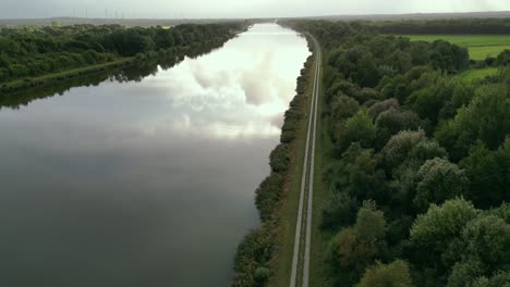 Relaxing-aerial-shot-over-the-water-canal-with-nice-sun-behind-clouds