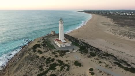 Reveal-Drone-Shot-Of-Trafalgar-Lighthouse-On-The-Costa-De-La-Luz-In-Caños-De-Meca,-Cadiz-Andalucia,-Spain