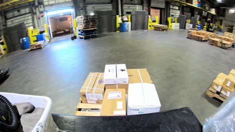 POV-timelapse-of-pallet-jack-moving-delivering-packages-from-truck-to-warehouse