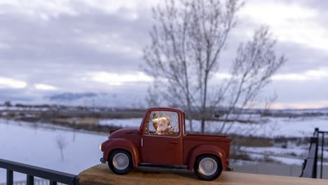 Santa-Claus-in-a-red,-toy-truck-as-the-sunset-turns-to-sundown---motion-time-lapse-cloudscape