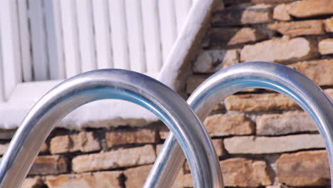 Reflection-on-a-metallic-pool-railing