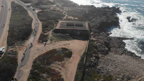 Aerial-view-of-some-ruins-near-Cabo-Raso-Lighthouse-in-sunny-day-in-Cascais-Portugal