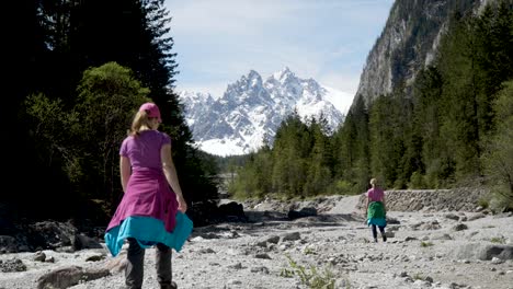 Two-women-hiking-through-stone-valley-next-to-river-in-German-Alps-near-Berchtesgaden-Wimmbachklamm