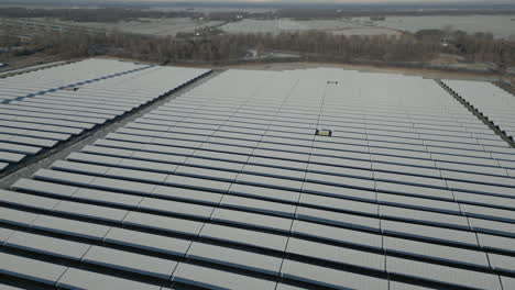 Solar-panels-of-solar-power-plant-covered-in-snow-and-ice,-frosty-landscape,-drone-shot,-slow-movement-forward