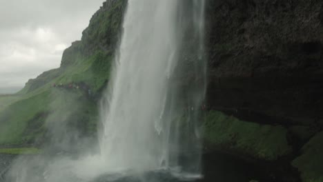 Tilt-down-from-in-front-of-a-waterfall-in-Iceland