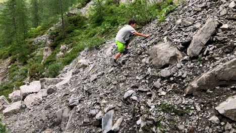 Cute-young-boy-doing-well-while-climbing-mountain-full-of-rubble
