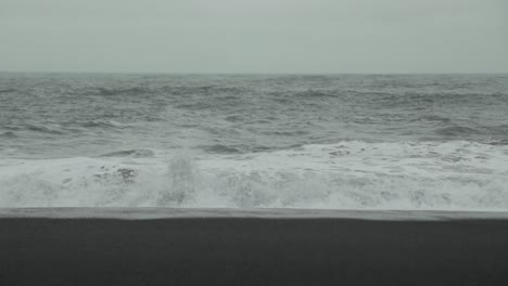 Waves-crash-on-a-black-sand-beach-in-Iceland