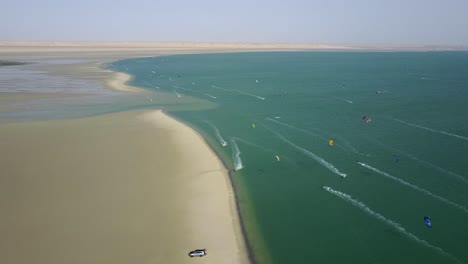 Drone-footage-of-dozens-of-kite-surfers-in-Dakhla,-Morocco