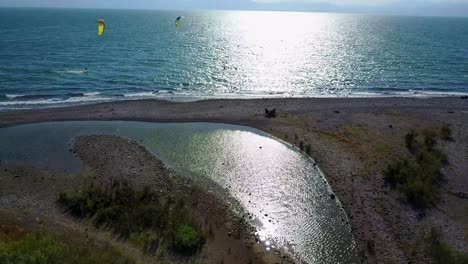 Aerial-shot-of-kitesurfers-on-the-coast-of-the-Sea-of-Galilee