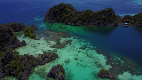 Drone-following-a-boat-into-the-tropical-coral-reefs-and-islands-of-Piameno-in-Raja-Ampat,-Indonesia