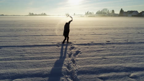 Little-boy-playing-in-the-snow-on-big-field