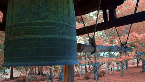 Big-Japanese-bell-surrounded-by-trees-in-the-autumn-season-in-Kyoto,-Japan-soft-lighting