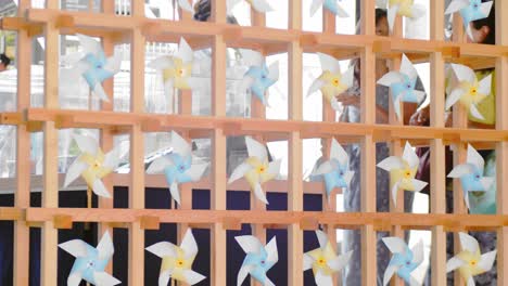 Slide-shot-of-paper-windmills-hung-up-for-decor-in-Kyoto,-Japan-4K-slow-motion