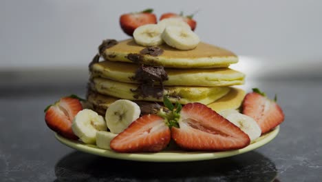 American-Pancakes-With-Strawberries-And-Bananas-In-The-Kitchen