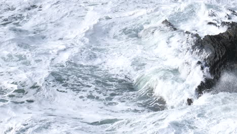 Stormy-Ocean-Waves-Crashing-Against-Rocky-Shore-Surface-Turmoil
