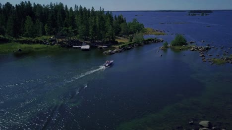 Tracking-aerial-of-boat-cruising-between-summer-islets