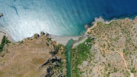 Aerial-top-down-view-of-the-gorgeous-Preveli-beach,-a-paradisiac-place-in-the-island-of-Crete