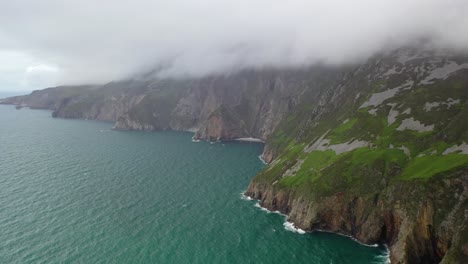 Low-clouds-above-Slieve-League-cliffs-and-rugged-coastline-in-Ireland,-aerial