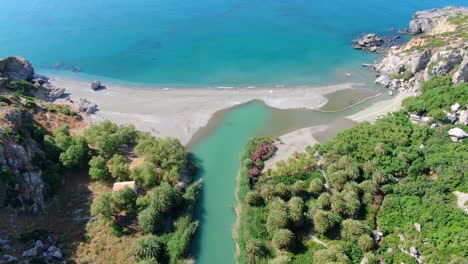 Aerial-revealing-Preveli-beach,-a-paradisiac-place-on-the-southern-coast-of-Crete