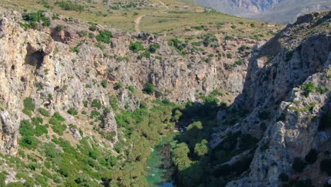 Aerial-flying-through-a-gorge-over-Kourtaliotis-river-in-the-island-of-Crete,-Greece