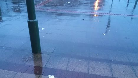 Windy-storm-Ciara,-UK-heavy-torrential-rainy-day-weather-on-urban-city-pavement