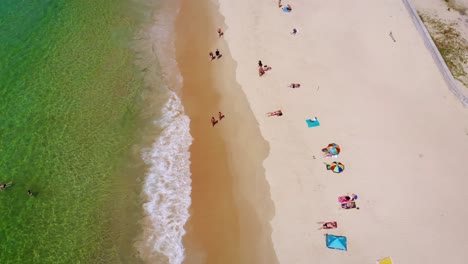 Aerial-top-down-shot-of-people-enjoying-an-incredible-beach-in-Phuket,-Thailand