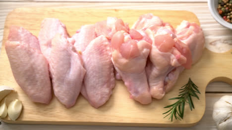 fresh-raw-chicken-wings-on-wooden-board-with-ingredients