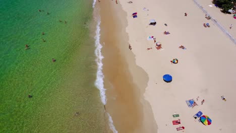 Aerial-High-angle-view-of-people-enjoy-swimming-and-relax-on-the-beach-in-Phuket-Thailand