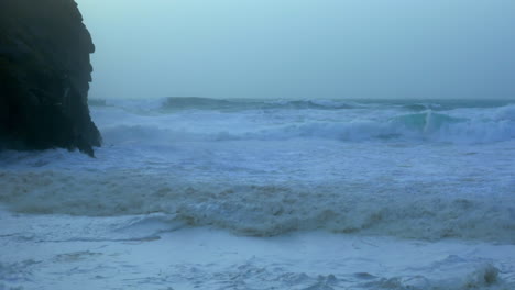 The-violent-waves-in-Chapel-Porth-beach,-UK-during-storm-Ciara---slow-motion