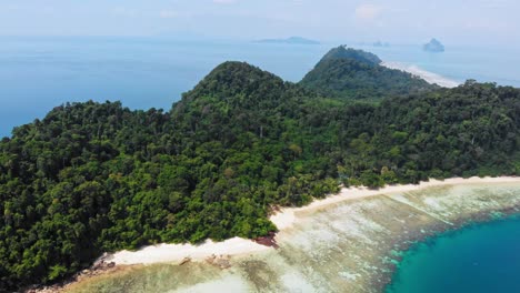 Aerial-shot-of-green-hills-on-tropical-island-on-Andaman-Sea-in-Thailand---Koh-Kradan