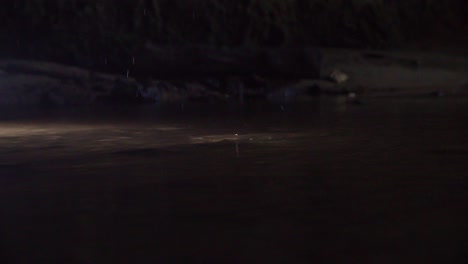 A-slow-motion-shot-of-a-rock-drop-into-the-water-surface-creating-a-splash