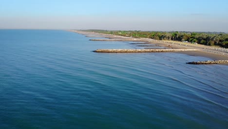 Aerial-view-of-Caorle-beach-and-breakwaters,-on-the-Adriatic-Coast-in-Northern-Italy