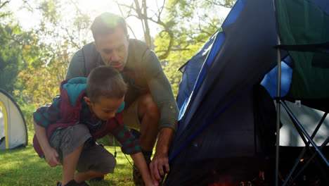 Father-and-son-setting-up-a-tent