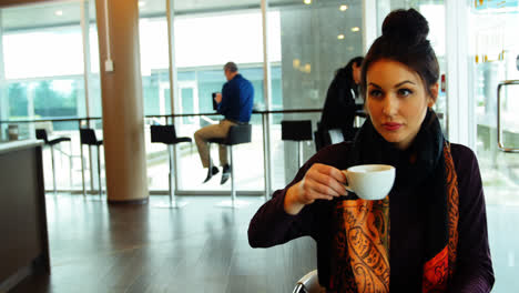 Female-executive-working-while-having-coffee