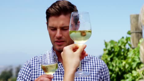 Couple-drinking-wine-in-vineyard