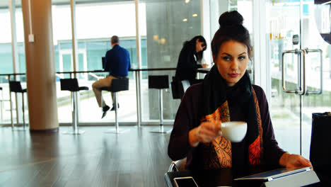 Female-executive-working-while-having-coffee