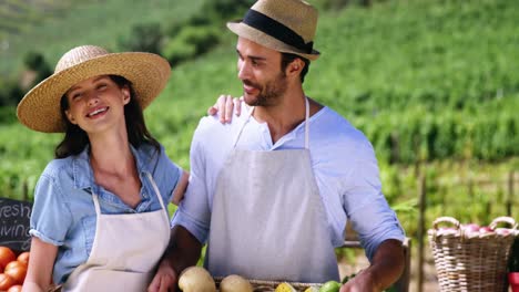 Happy-couple-standing-in-farm