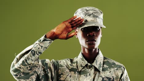 Androgynous-man-in-camouflage-uniform-against-green-background