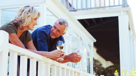 Älteres-Paar-Interagiert-Miteinander,-Während-Es-Auf-Dem-Balkon-Wein-Trinkt