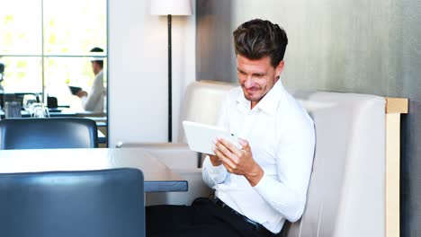 Smiling-man-using-digital-tablet