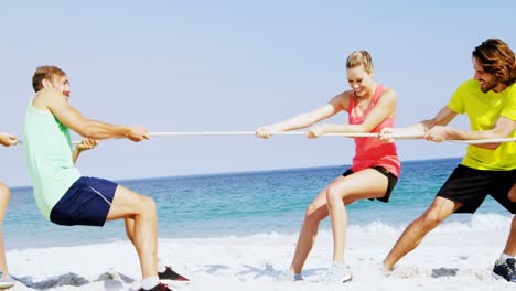 Friends-playing-tug-of-war-on-the-beach